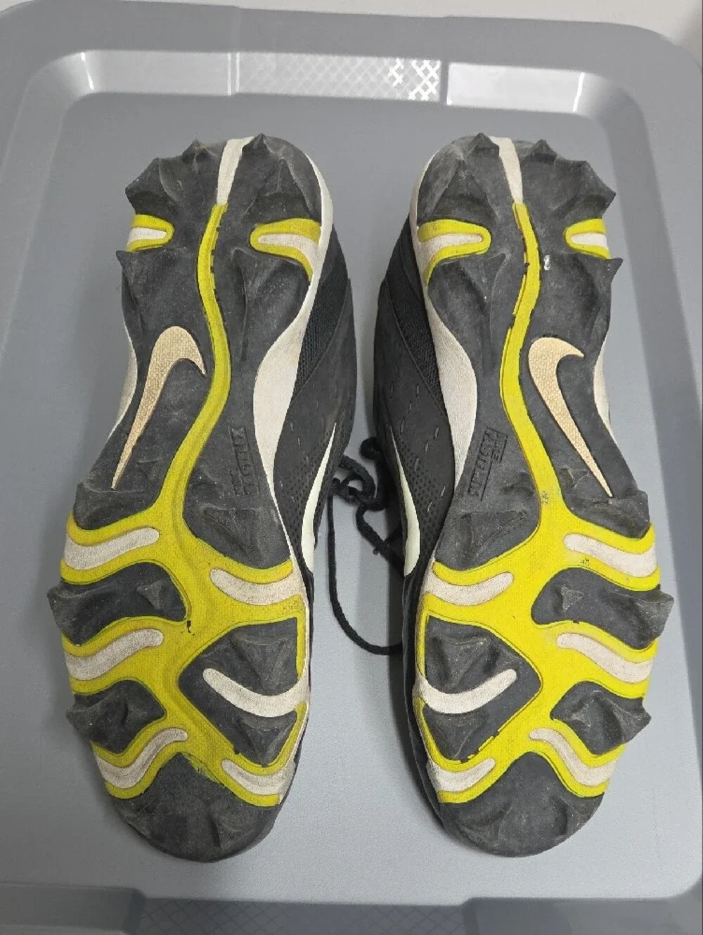 Nike Black and White Youth Athletic Cleats with Yellow Studs